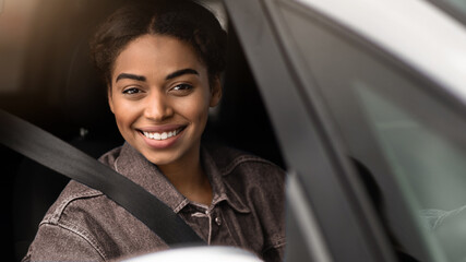 Great auto offer, car advertisement and modern blogger. Smiling happy young african american woman...