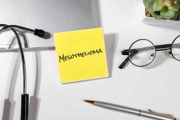 Doctor’s Desk with “Mesothelioma” Note – Asbestos-Related Cancer Reminder with Pen and Medical Tools