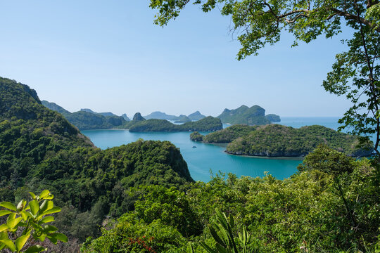 A wide-angle landscape photo of Mu Ko Ang Thong National Marine Park, located an hour's boat ride from Koh Samui. It features numerous small islands covered in lush tropical vegetation and a turquoise