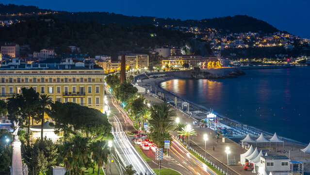 Fototapeta Evening aerial panorama of Nice day to night timelapse, France. Lighted Old Town little streets and waterfront after sunset