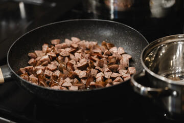 Frying Pan Full of Sizzling Sausage: Home Cooking Tasty Pieces of Meat for Lunch or Dinner