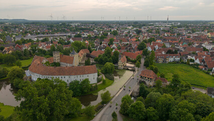A panoramic drone view of the city and the castle, which sits on the water, in Steinfurt, Germany (Wasserschloss Burgsteinfurt)