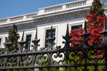 White Mansion Behind Black Wrought Iron Fence in Savannah Georgia