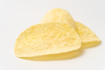 Close-up of three potato chips on a white background. Crispy texture and light seasoning visible. Ideal for snack advertisements, packaging, and food-related concepts