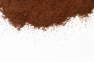 Ground coffee scattered on a white background with clean space below. Ideal for food design,...