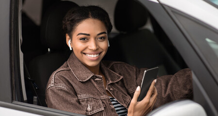 Driving work, modern taxi driver and profession in city. Smiling young african american woman in...
