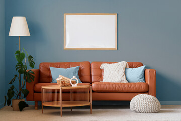 Interior of living room with brown sofa, table and lamp