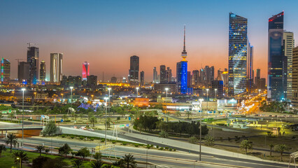 Fototapeta premium Skyline with Skyscrapers day to night timelapse in Kuwait City downtown illuminated at dusk. Kuwait City, Middle East