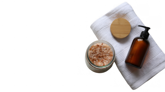 Himalayan pink salt in a glass jar, next to a dispenser and a white towel on a transparent background, composing a relaxing spa kit, promoting wellness and body care