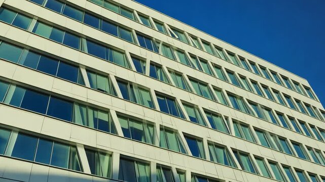 Modern office building exterior with white metal cladding and glass windows. motion video.