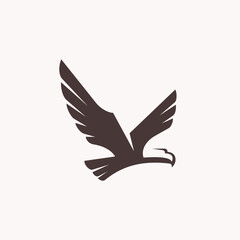 a silhouette of an eagle flying logo