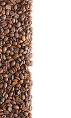 Many roasted coffee beans on white background. Coffee beans border with area for copy space. Close up images.