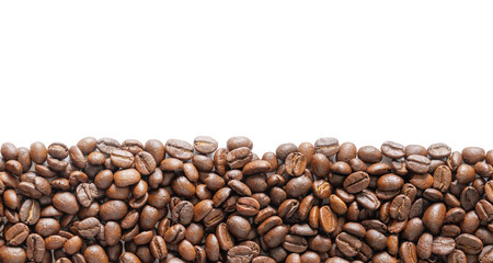 Many roasted coffee beans on white background. Coffee beans border with area for copy space. Close up images.