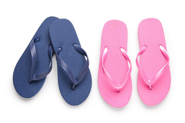 Colorful pairs of female flip flops on white background