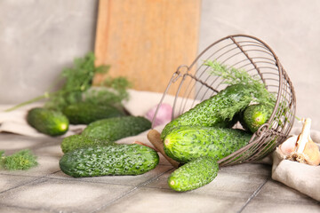 Basket with fresh cucumbers on table