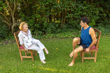 Physiotherapist assisting senior woman with rehabilitation exercises outdoors