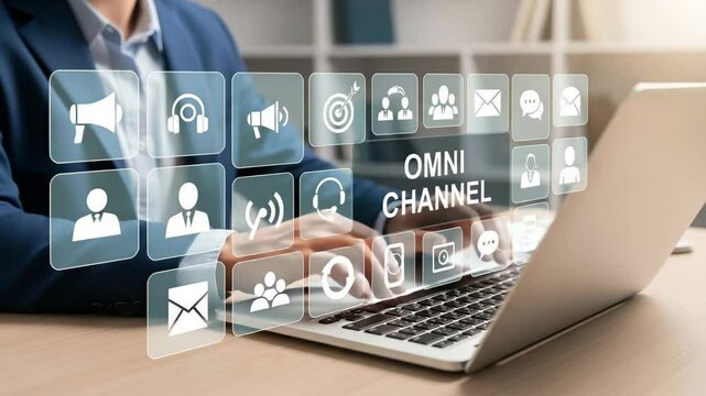 Person typing on laptop with omni channel icons overlaid in a business setting and wearing a suit