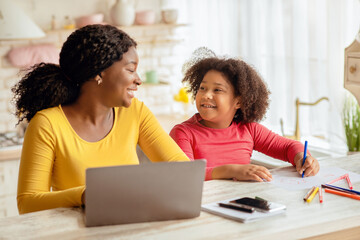 Happy Black Mom And Her Little Daughter Spending Time Together In Kitchen, Cute Preschool Girl...