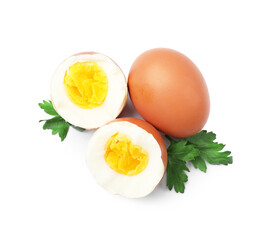 Hard boiled eggs and parsley on white background, top view