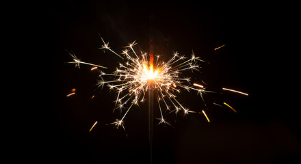 Glowing party sparkler captured mid-burn, perfect for night celebration themes.