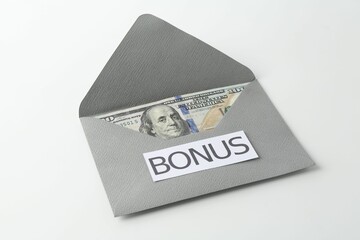 Envelope with word Bonus and dollar banknotes isolated on white