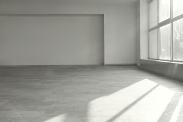 View of light empty room with large window
