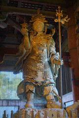 Nara, Japan - Sep 26 2024, vertical view from below of ancient wooden statue of Tamonten Bishamonten, one of Guardians of Four Directions, in Todaiji Temple, without people, Nara, Japan