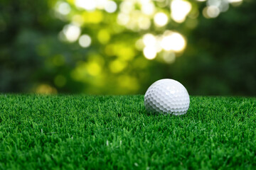 Golf ball on green grass outdoors, closeup