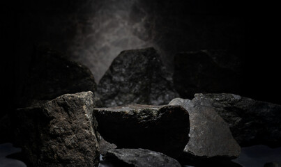 black stones with texture on dark background for cosmetic podium backdrop