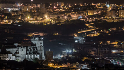 Fototapeta premium Rooftops of Porto's old town aerial night timelapse, Porto, Portugal