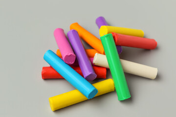 Heap of colorful plasticine on grey background, closeup