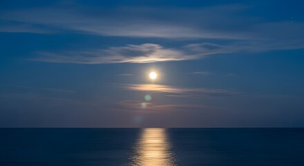 Naklejka premium Moon Over the Ocean Reflecting on Water