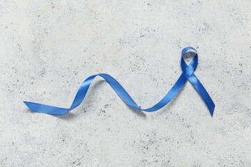 Blue ribbon on white grunge background. Prostate cancer awareness concept