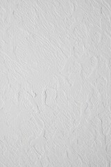 close-up of white textured wall with rough and uneven plaster surface