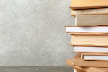 Stack of books on grey background