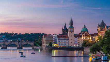 Obraz premium View of the city Prague in Czech Republic day to night timelapse on the Vltava river with beautiful sky