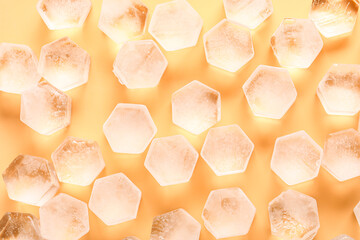 Frozen ice in shape of hexagon on yellow background, closeup
