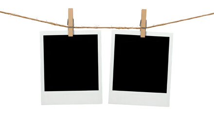 Two blank Polaroid photo frames clipped to a rope with wooden pegs, isolated on white or transparent background. PNG, perfect for nostalgia-themed designs, scrapbooks, or memory placeholders.