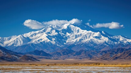 Fototapeta premium Majestic Snow-Capped Mountain Range Under a Clear Blue Sky