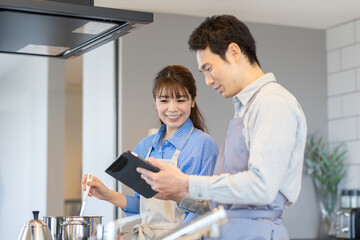 キッチンに立つ夫婦 © milatas