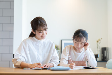 子供の勉強を見る母