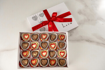 Box of assorted chocolates with the lid open_top view.