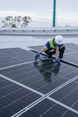 Engineers install solar panels on a wet rooftop during cloudy weather