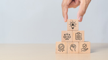 Wooden cubes with concept of Copyright or patent idea representing legal rights to inventions, intellectual property protection, and licensed brand ownership