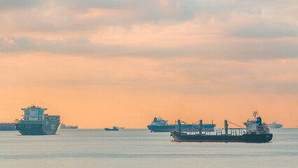 Early morning scene of cargo ships and tankers anchored off of Singapore's coast timelapse