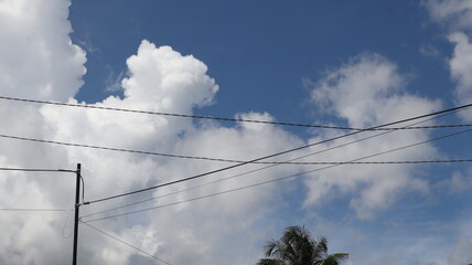 Network of electric cables on electric poles with a clear blue sky in the afternoon