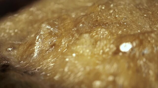 Closeup shot of deep frying potatoes. Oil boiling closeup.