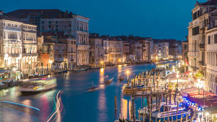 Grand Canal in Venice, Italy day to night timelapse. Gondolas and city lights from Rialto Bridge.