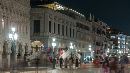 Obraz premium Waterfront and the bridge Ponte della Paglia timelapse near Palace of the doges and the palazzo delle Prigioni at night.