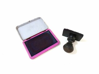 Black wooden rubber stamp with stamp pad isolated on white background, business approval concept. 